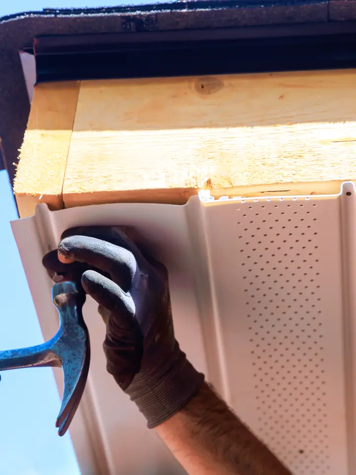 New uPVC soffit board being fixed under the eaves