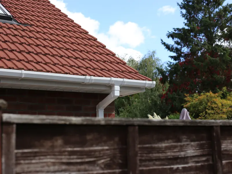 White gutter and fascia on a red tiled roof