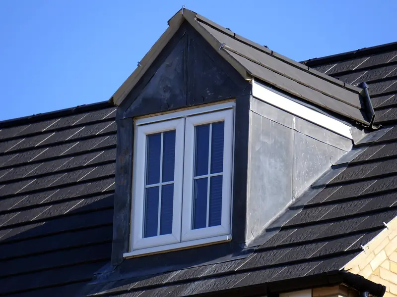 New dark tiled roof with a lead-clad dormer