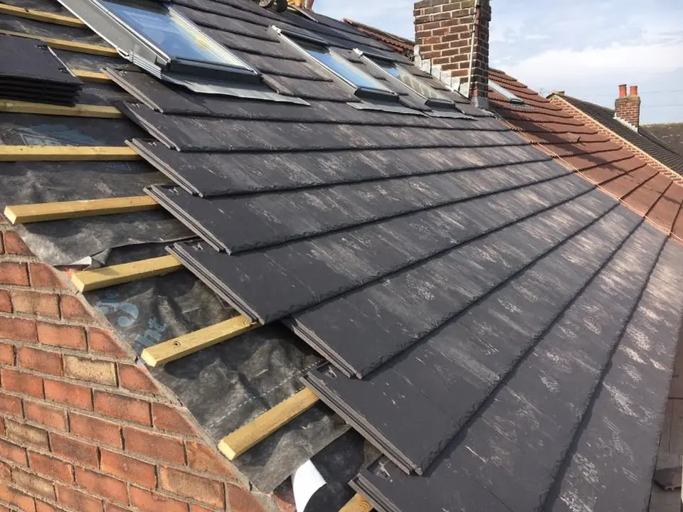 Slates nailed to new battens on a roof