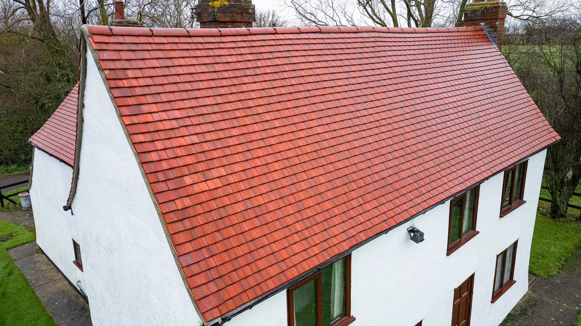 White cottage with a new red clay tiled roof